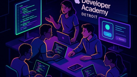 Grupa studentów pracujących nad kodowaniem w nowoczesnej klasie.